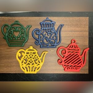 4 cast iron trivets marked WMG 2009